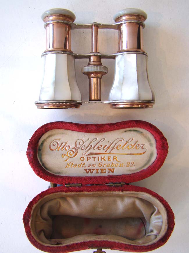 A fine pair of late 19th century Austrian Opera Glasses with their original red velvet purse/case